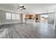 Inviting living space with gray flooring, sliding glass doors to the patio, and open access to the kitchen at 9750 Maple Sugar Leaf Pl, Las Vegas, NV 89148