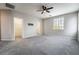 Large bedroom with gray carpet, a ceiling fan, and a walk-in closet at 9750 Maple Sugar Leaf Pl, Las Vegas, NV 89148