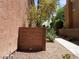 Cozy backyard with rock landscaping, a brick wall, and mature trees at 9937 La Paca Ave, Las Vegas, NV 89117