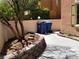 Backyard with brick retaining wall, desert landscape, and trash bins at 9937 La Paca Ave, Las Vegas, NV 89117