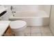 Clean bathroom with a white toilet and soaking tub, offering a simple design at 9937 La Paca Ave, Las Vegas, NV 89117