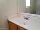 A bathroom with single sink vanity and a large mirror showcasing natural light at 9937 La Paca Ave, Las Vegas, NV 89117