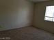 Bedroom featuring neutral carpet, light walls, and a window with natural light at 9937 La Paca Ave, Las Vegas, NV 89117