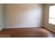 Spacious bedroom featuring wood-look floors, light walls, and a bright window at 9937 La Paca Ave, Las Vegas, NV 89117