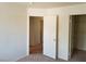 Bedroom with an open doorway, access to a closet, and neutral carpeting at 9937 La Paca Ave, Las Vegas, NV 89117