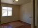 Bedroom showcasing a window with natural light and wood-look flooring at 9937 La Paca Ave, Las Vegas, NV 89117