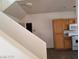 An interior view of the staircase with access to the kitchen featuring essential appliances at 9937 La Paca Ave, Las Vegas, NV 89117