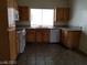 A kitchen with essential appliances and wooden cabinets over tile flooring at 9937 La Paca Ave, Las Vegas, NV 89117