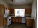 A kitchen with essential appliances and wooden cabinets over tile flooring at 9937 La Paca Ave, Las Vegas, NV 89117