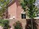 Side view of a home with block wall, bushes, flowers, and a small tree at 9937 La Paca Ave, Las Vegas, NV 89117