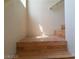 Staircase featuring wood steps and bright, natural light from a nearby window at 9937 La Paca Ave, Las Vegas, NV 89117