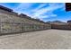 Expansive backyard with a black fence, and a backdrop of desert landscaping and mountain views at , Henderson, NV 89011