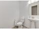 Well-lit powder room with a pedestal sink and gray tile flooring at , Henderson, NV 89011