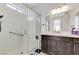 Accessible bathroom with walk-in shower, grab bars, double sinks with white countertops, and dark cabinetry at , Henderson, NV 89011