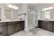 Bright bathroom featuring double sinks, white countertops, dark cabinetry, and glass enclosed shower at , Henderson, NV 89011