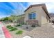 Tan desert home boasts desert landscaping and a brick driveway, with a hill in the background at , Henderson, NV 89011