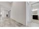 Hallway featuring tile floors, white walls, and doorways to a bathroom and bedroom at , Henderson, NV 89011