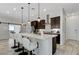 Modern kitchen with a large island, white countertops, bar stool seating, and stainless steel appliances at , Henderson, NV 89011