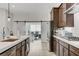 Bright kitchen with white countertops, dark cabinetry, stainless steel appliances, and an adjacent office area at , Henderson, NV 89011
