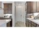 Well-equipped kitchen with white countertops, dark cabinets, stainless steel appliances, and access to hallway at , Henderson, NV 89011