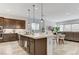 Open kitchen and living area featuring dark cabinets, stainless appliances and tile flooring at , Henderson, NV 89011