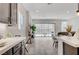Stylish kitchen with white countertops, dark cabinets, stainless steel appliances, and a view of the living area at , Henderson, NV 89011