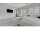 Spacious main bedroom features tile flooring, a mounted tv, and scenic views from the bright windows at , Henderson, NV 89011