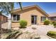Home exterior view showing a brick patio and desert landscaping with a sliding glass door entrance at , North Las Vegas, NV 89084