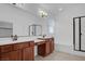 This bathroom features wood cabinets, double sinks, and a large mirror at , North Las Vegas, NV 89084