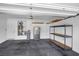 Spacious garage with epoxy floor, shelving, water heater, and overhead storage racks at , North Las Vegas, NV 89084