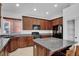 Well-equipped kitchen featuring granite countertops and dark wood cabinets at , North Las Vegas, NV 89084