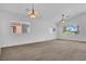 Spacious living room with a ceiling fan, recessed lights, and two large windows at , North Las Vegas, NV 89084
