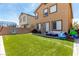 Spacious backyard with artificial turf, patio area, and play equipment at 10086 Adina Ct, Las Vegas, NV 89141