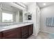 Bathroom with a double sink vanity, granite countertops, and modern fixtures at 10086 Adina Ct, Las Vegas, NV 89141