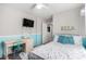 Bright bedroom featuring a desk, TV, and a cozy bed with decorative pillows and light walls at 10086 Adina Ct, Las Vegas, NV 89141