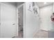 Hallway leads to a bathroom and features neutral tile and decorative wall art at 10086 Adina Ct, Las Vegas, NV 89141
