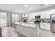 Modern kitchen with white cabinets, granite countertops, stainless steel appliances, and an island at 10086 Adina Ct, Las Vegas, NV 89141