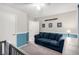 Cozy living room area features a comfortable blue sofa and aviation themed decorations at 10086 Adina Ct, Las Vegas, NV 89141