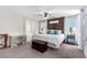 Spacious main bedroom featuring a decorative wooden headboard, ample natural light, and stylish furnishings at 10086 Adina Ct, Las Vegas, NV 89141