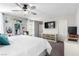 Large main bedroom featuring a decorative wooden headboard, ample natural light, and mounted television at 10086 Adina Ct, Las Vegas, NV 89141