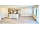 Open-concept kitchen featuring stainless steel appliances, gray cabinets, an island, and wood grain flooring at 10388 Luna Mezza Ave # Lot 4195, Las Vegas, NV 89141