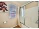 Bathtub and shower with glass sliding door and window with blinds in bathroom at 10456 Prairie Schooner Ave, Las Vegas, NV 89129