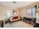 Spare bedroom with comfortable seating area, futon, piano, and carpeted flooring, providing a flexible space at 10456 Prairie Schooner Ave, Las Vegas, NV 89129