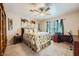 Bedroom with neutral carpet, ceiling fan, large bed, and built-in bookcase for plenty of storage at 10456 Prairie Schooner Ave, Las Vegas, NV 89129