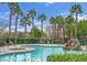 Resort-style community pool with a rock waterfall feature and plenty of seating areas at 10456 Prairie Schooner Ave, Las Vegas, NV 89129