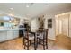 Open dining area boasts wood floors, table for four, and kitchen access with bright natural lighting at 10456 Prairie Schooner Ave, Las Vegas, NV 89129