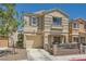 Inviting two-story house showcasing a cozy porch, attached garage, and tidy front yard at 10456 Prairie Schooner Ave, Las Vegas, NV 89129