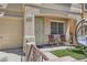 Inviting front porch offers comfortable seating, artificial turf, and stylish decor at 10456 Prairie Schooner Ave, Las Vegas, NV 89129