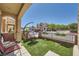 Cozy front porch featuring an egg chair, seating area, and artificial turf at 10456 Prairie Schooner Ave, Las Vegas, NV 89129