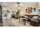 Spacious living room with cozy seating, stylish decor, and access to the kitchen at 10456 Prairie Schooner Ave, Las Vegas, NV 89129